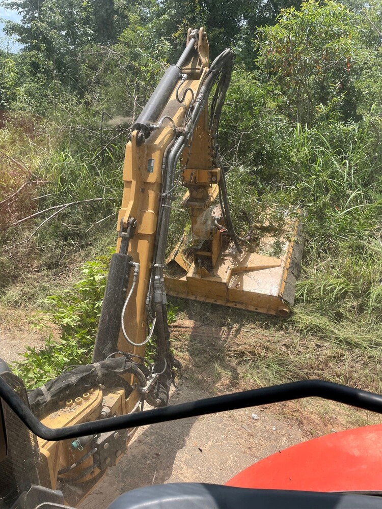 BClean tractor trimming tall grass